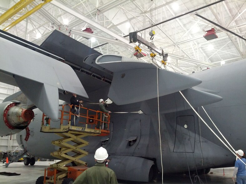 WRIGHT-PATTERSON AIR FORCE BASE, Ohio - Airmen from both 445th Maintenance and 445th Aircraft Maintenance Squadrons work together during a Home Station Check Inspection Feb. 26 to replace the inboard flap that incurred weather damage. (Courtesy photo)  
