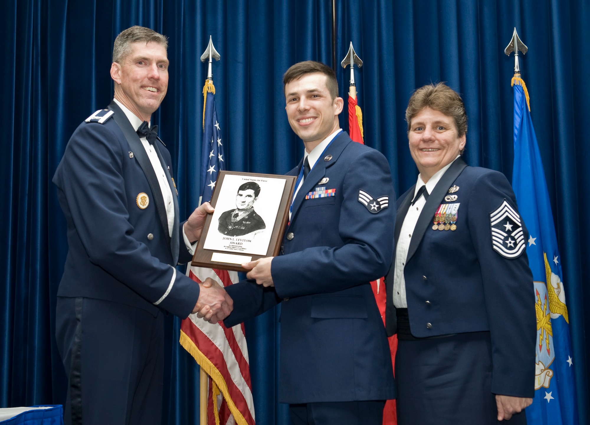 Senior Airman Jason Rimer, 39th Contracting Squadron contract specialist, receives the John L. Levitow Award from Col. Chris Craige, 39th Air Base Wing commander, during the Class 13-3 graduation Mar. 28, 2013, at Incirlik Air Base, Turkey. The Levitow Award is the highest achievement for enlisted Airmen enrolled in U.S. Air Force professional military education. There are four levels of PME: ALS, NCO Academy, Air Force Senior NCO Academy and Chief Master Sergeant Leadership Course. (U.S. Air Force photo by Staff Sgt. Marissa Tucker/Released)