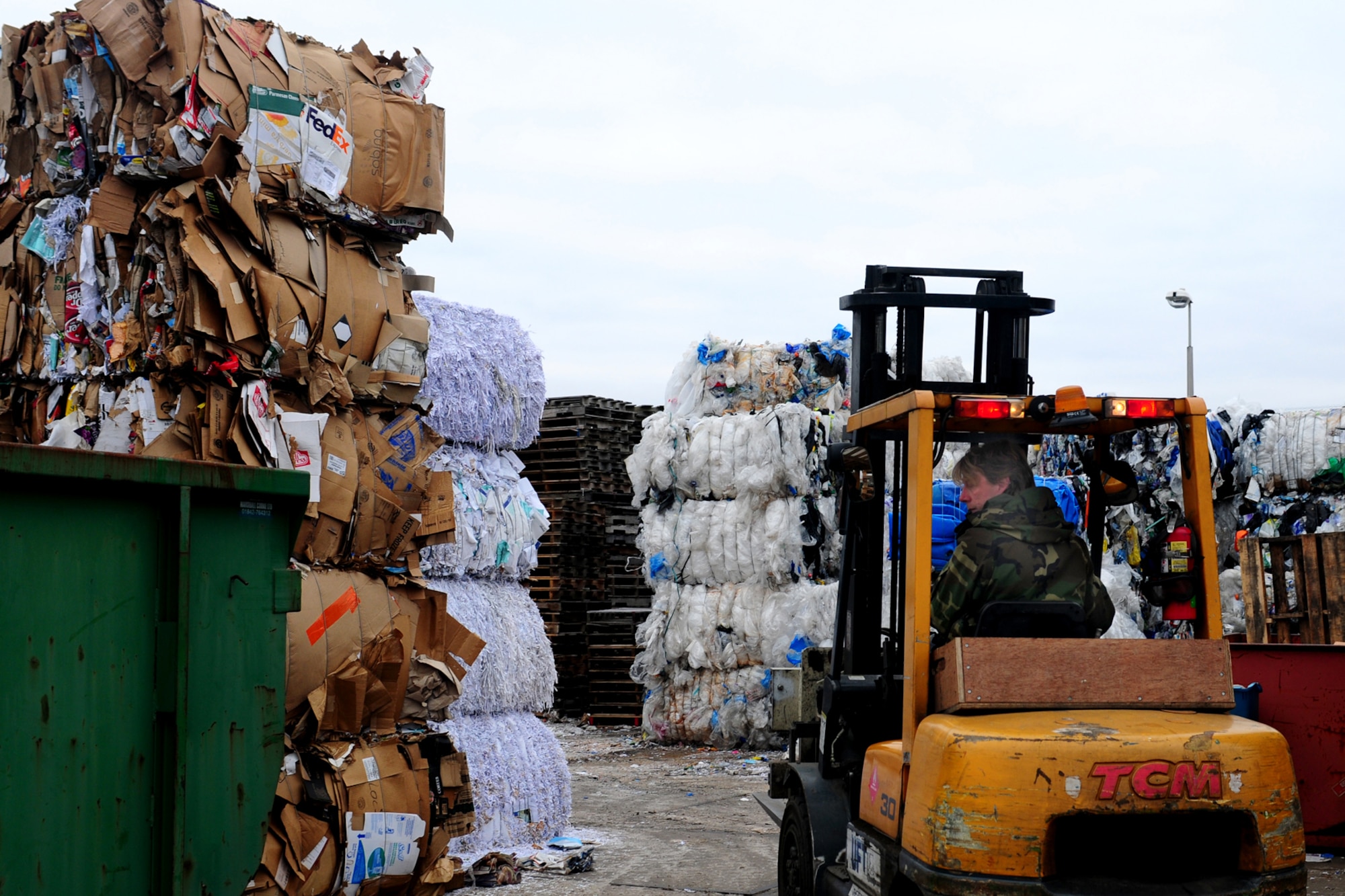 ROYAL AIR FORCE LAKENHEATH, England -- Robert Cooper, 48th Civil Engineer Squadron recycling technician, stacks bales of recyclables for distribution Feb. 22, 2013. The recycling center processes up to ten percent of all recyclables on RAFs Lakenheath and Feltwell. (U.S. Air Force photo by Airman 1st Class Dana J. Butler)