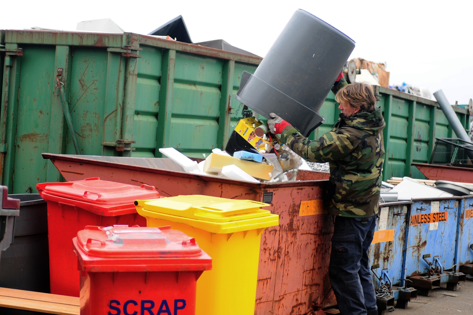ROYAL AIR FORCE LAKENHEATH, England -- Robert Cooper, 48th Civil Engineer Squadron recycling technician, sorts through recyclables Feb. 22, 2013. According to Cooper sorting through the materials is his favorite part of the job, because "you never really know what's going to turn up, it's always something unusual." (U.S. Air Force photo by Airman 1st Class Dana J. Butler)