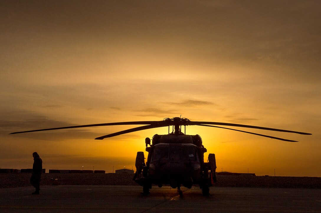 A U.S. Air Force HH-60G Pave Hawk sits on a landing pad during the sunrise on Camp Bastion, Afghanistan, March 11, 2013. The primary mission of the HH-60G Pave Hawk helicopter is to conduct day or night personnel recovery operations into hostile environments to recover isolated personnel. (U.S. Air Force photo/Tech. Sgt. Dennis J. Henry Jr.)