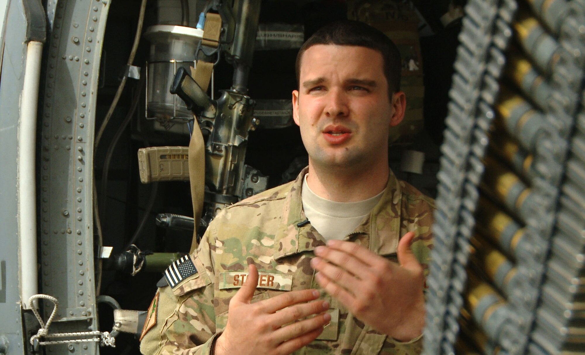 Senior Airman Austin Stoker, 26th Expeditionary Rescue Squadron munitions systems technician, explains the capabilities of weapons and ammunition aboard a U.S. Air Force HH-60G Pave Hawk March 11, 2013, at Bastion Airfield, Afghanistan. Stoker is responsible for maintaining the squadron’s entire weapon stockpile and is deployed from the 129th Rescue Wing, Moffett Federal Airfield, Calif. (U.S. Air Force photo/Senior Airman Robert Harnden)