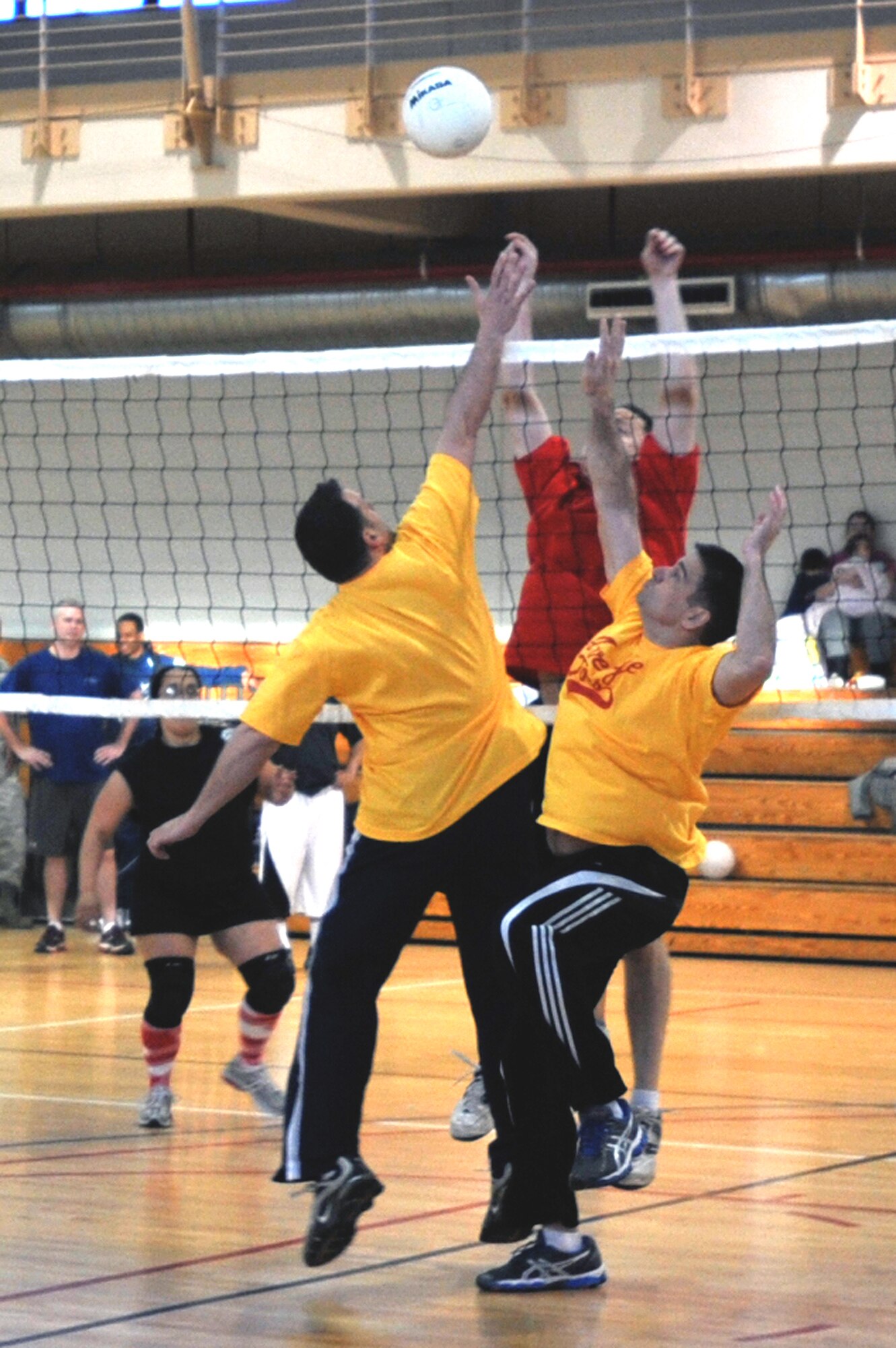 The Chiefs and Top 3 members guard the net in the heated final round of the Battle of the Tiers volleyball tournament at the Osan Fitness Center on Osan Air Base, Republic of Korea, March 29, 2013. The Top 3 took the title in the tournament. (U.S. Air Force photo/Senior Airman Alexis Siekert)
