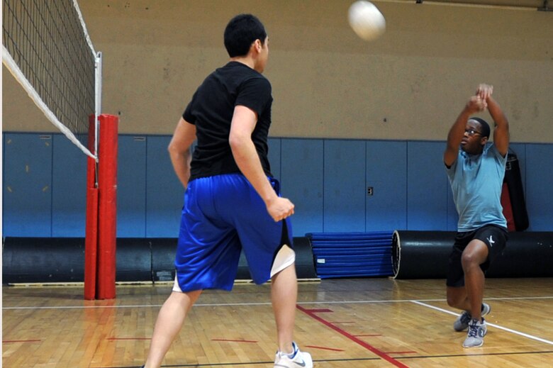 Players from the Osan Junior Enlisted Council team return the ball in the Battle of the Tiers volleyball tournament at the Osan Fitness Center on Osan Air Base, Republic of Korea, March 29, 2013. The OJEC team defeated the Company Grade Officer team but was defeated by the chiefs. (U.S. Air Force photo/Senior Airman Alexis Siekert)