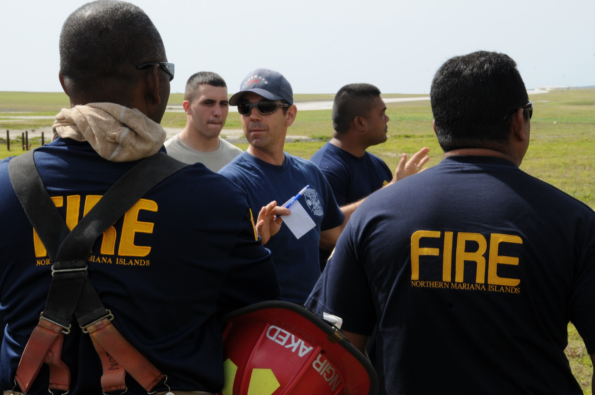Jason Crandall, 36th Civil Engineer Squadron Fire and Emergency Services crew chief, briefs Andersen and Saipan fire personnel before a structural fire exercise on Andersen Air Force Base, Guam, March 27, 2013. Andersen Fire and Emergency Services personnel hosted four Saipan fire officers for joint fire training during their visit to Guam March 25-29. (U.S. Air Force photo by Staff Sgt. Melissa B. White/Released)