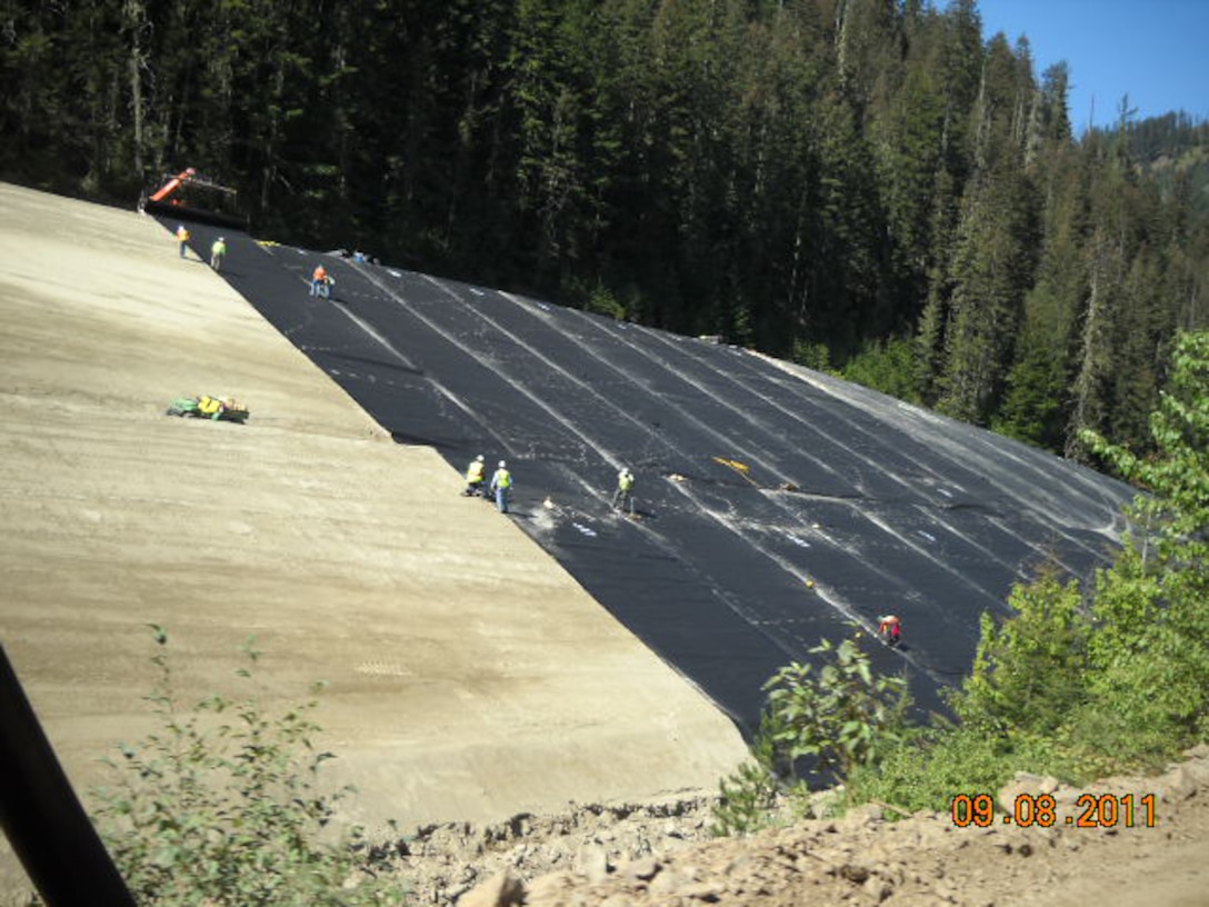 This photo shows installation of the geomembrane cover in progress at Tailing Pile 3.