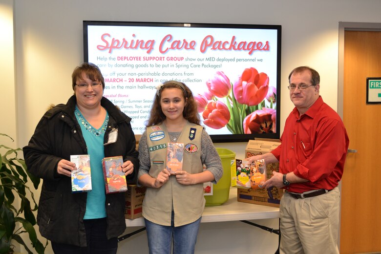 Sorina (left) and Abby Neaverth donated four cases of Girls Scout Cookies to the Deployee Support Group for the spring care packages. Chairman John Ballard accepted the donation.