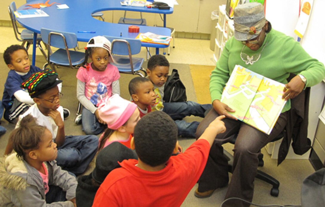 Barbara Tolliver, Huntsville Center Business Management Office, reads to Montview Elementary School kindergarten  students during Read Across America Day. 