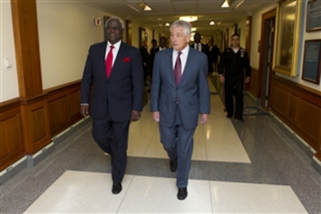 Secretary of Defense Chuck Hagel, right, escorts Sierra Leone President Bai Koroma to a joint meeting with Malawi President Joyce Banda and Cape Verde Prime Minister Jose Maria Neves in the Pentagon on March 28, 2013.  