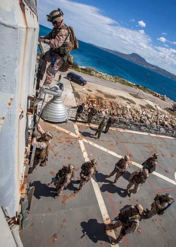 A 26th Marine Expeditionary Unit (MEU) Maritime Raid Force Marine conducts a vessel boarding technique with a climbing ladder aboard the HS Aris at the NATO Maritime Interdiction Operational Training Centre in Souda Bay, Crete, Greece, March 27, 2013. The 26th MEU is deployed to the 6th Fleet area of operations. The 26th MEU operates continuously across the globe, providing the president and unified combatant commanders with a forward-deployed, sea-based quick reaction force. The MEU is a Marine Air-Ground Task Force capable of conducting amphibious operations, crisis response and limited contingency operations. (U.S. Marine Corps photo by Cpl. Christopher Q. Stone/Released) 

