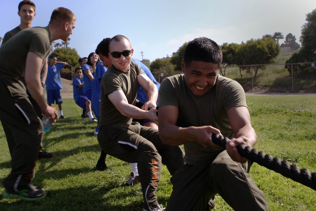 Marines lend a hand and some muscle to a group of students during a tug-of-war competition at Jefferson Middle School, March 29. Camp Pendleton’s Single Marine Program and Marine volunteers tested a pilot fitness challenge to promote physical education while giving back to the community.  