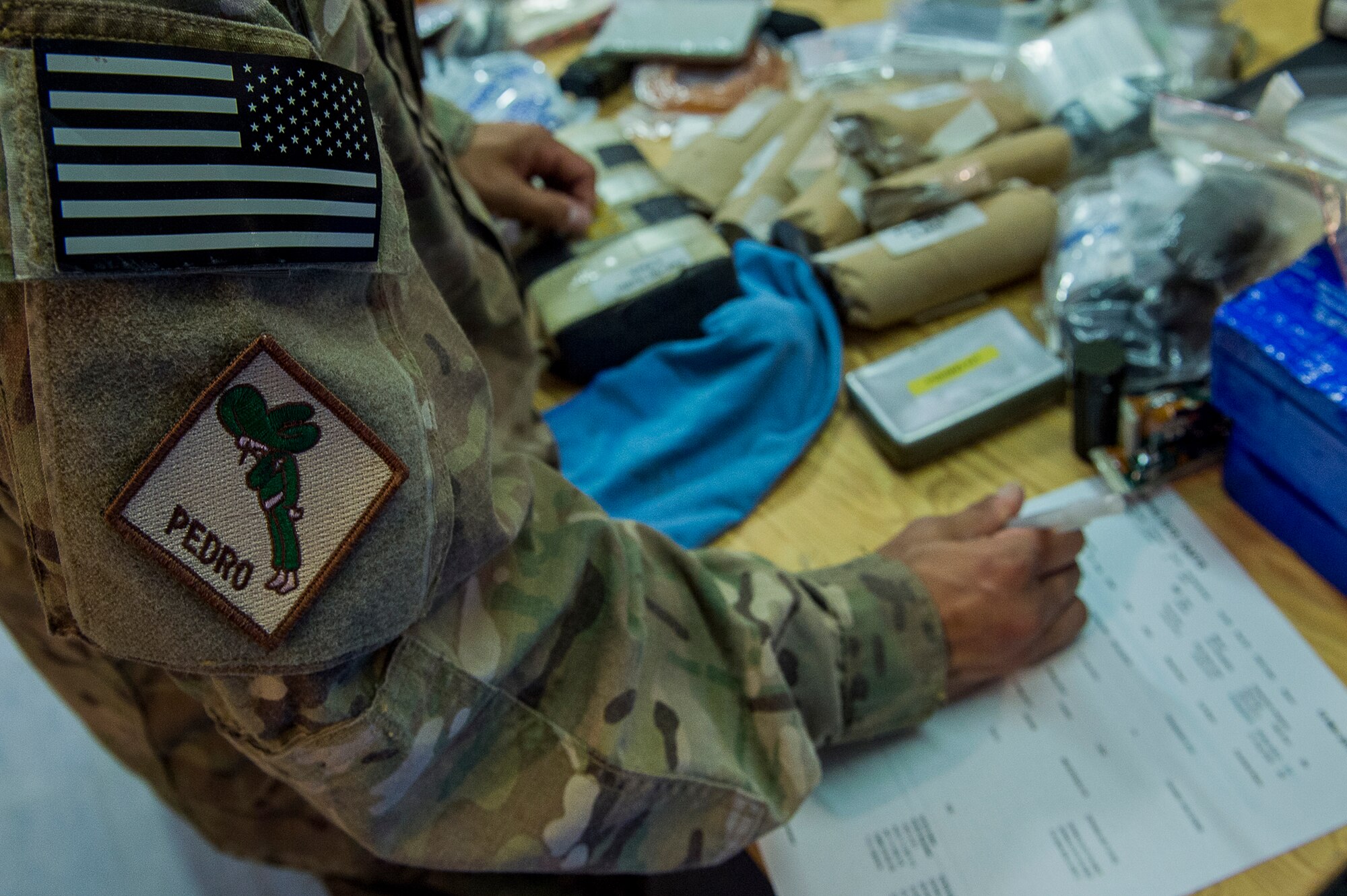 U.S. Air Force Airman 1st Class Cris Dingle, an aircrew flight equipment specialist deployed to the 26th Expeditionary Rescue Squadron, inspects a nine-man flotation device on Camp Bastion, Afghanistan, March 10, 2013. Dingle is responsible for flight equipment such as helmets, oxygen masks, parachutes, flotation devices, survival kits, night vision goggles, anti-G garments, aircrew eye and respiratory protective equipment and other types of AFE. Dingle is from the 129th Rescue Wing, California Air National Guard, Moffett Federal Airfield, Calif. (U.S. Air Force photo/Tech. Sgt. Dennis J. Henry Jr.)