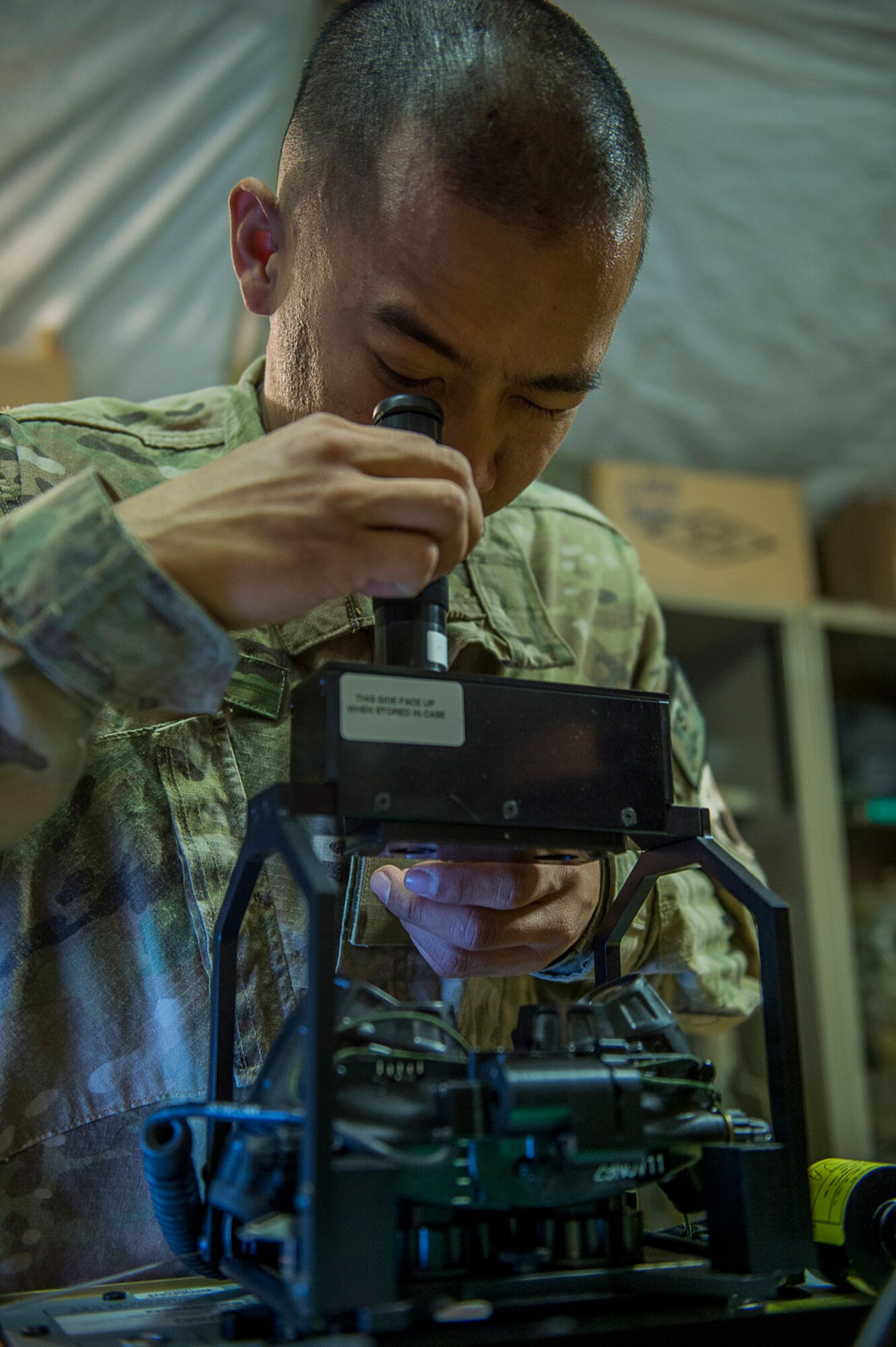 U.S. Air Force Airman 1st Class Cris Dingle, an aircrew flight equipment specialist deployed to the 26th Expeditionary Rescue Squadron, inspects panoramic night vision goggles on Camp Bastion, Afghanistan, March 8, 2013. Dingle is responsible for flight equipment such as helmets, oxygen masks, parachutes, flotation devices, survival kits, night vision goggles, anti-G garments, aircrew eye and respiratory protective equipment and other types of AFE. Dingle is from the 129th Rescue Wing, California Air National Guard, Moffett Federal Airfield, Calif. (U.S. Air Force photo/Tech. Sgt. Dennis J. Henry Jr.)