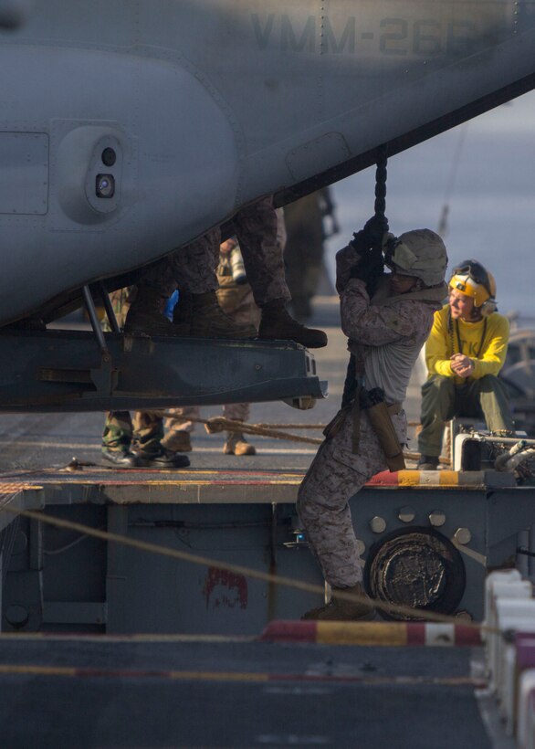 Marines and Sailors assigned to Battalion Landing Team 3/2, 26th Marine Expeditionary Unit (MEU), fast rope aboard the USS Kearsarge (LHD 3) while at sea, April 30, 2013. The 26th MEU is deployed to the 5th Fleet area of operations aboard the Kearsarge Amphibious Ready Group. The 26th MEU operates continuously across the globe, providing the president and unified combatant commanders with a forward-deployed, sea-based quick reaction force. The MEU is a Marine Air-Ground Task Force capable of conducting amphibious operations, crisis response and limited contingency operations. (U.S. Marine Corps photo by Cpl. Kyle N. Runnels/Released)