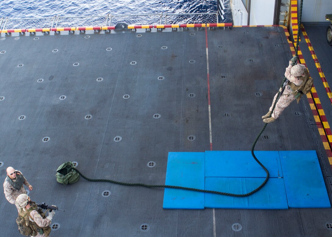 Marines and Sailors assigned to Battalion Landing Team 3/2, 26th Marine Expeditionary Unit (MEU), fast rope aboard the USS Kearsarge (LHD 3) while at sea, April 30, 2013. The 26th MEU is deployed to the 5th Fleet area of operations aboard the Kearsarge Amphibious Ready Group. The 26th MEU operates continuously across the globe, providing the president and unified combatant commanders with a forward-deployed, sea-based quick reaction force. The MEU is a Marine Air-Ground Task Force capable of conducting amphibious operations, crisis response and limited contingency operations. (U.S. Marine Corps photo by Cpl. Kyle N. Runnels/Released)