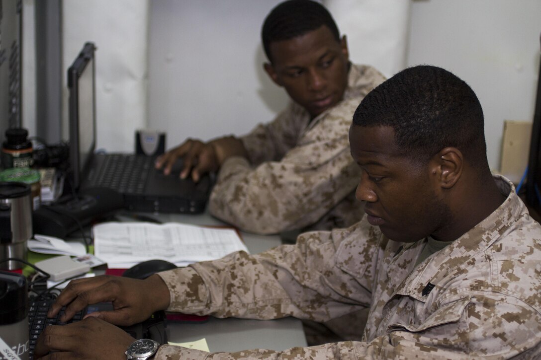 Sgt. Michael K. Burns and Cpl. Amadu Bah, administrative specialists assigned to the 26th Marine Expeditionary Unit (MEU), verify pay rosters aboard the USS Kearsarge (LHD 3) while at sea, April 29, 2013. The 26th MEU is deployed to the 5th Fleet area of operations aboard the Kearsarge Amphibious Ready Group. The 26th MEU operates continuously across the globe, providing the president and unified combatant commanders with a forward-deployed, sea-based quick reaction force. The MEU is a Marine Air-Ground Task Force capable of conducting amphibious operations, crisis response and limited contingency operations. (U.S. Marine Corps photo by Cpl. Kyle N. Runnels/Released)