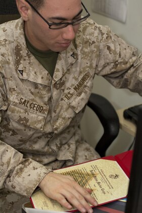 Lance Cpl. Roberto Salcedo, an administrative specialist assigned to the 26th Marine Expeditionary Unit (MEU), prepares a promotion warrant aboard the USS Kearsarge (LHD 3) while at sea, April 29, 2013. The 26th MEU is deployed to the 5th Fleet area of operations aboard the Kearsarge Amphibious Ready Group. The 26th MEU operates continuously across the globe, providing the president and unified combatant commanders with a forward-deployed, sea-based quick reaction force. The MEU is a Marine Air-Ground Task Force capable of conducting amphibious operations, crisis response and limited contingency operations. (U.S. Marine Corps photo by Cpl. Kyle N. Runnels/Released)
