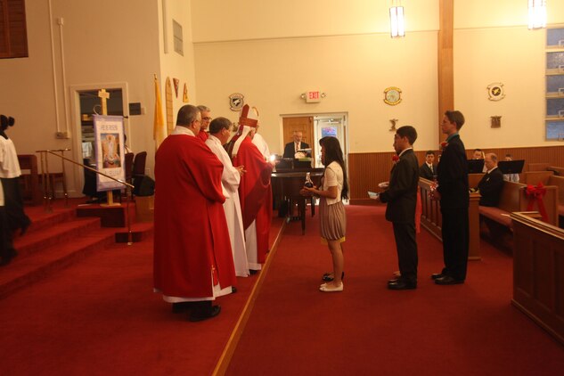 Justin Grabowski is anointed during his confirmation in the chapel aboard Marine Corps Air Station Beaufort, S.C., April 16. Being anointed signifies that the Catholic who is confirmed must always be ready to profess his faith openly and will practice it fearlessly.