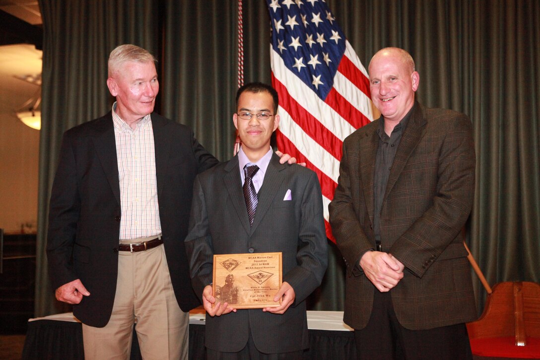 Cpl. John Wu, center, an airframes mechanic with Marine Fighter Attack Squadron 314, accepts his award with Lt. Gen. John Toolan, left, the 1st Marine Expeditionary Force commanding general, and Maj. Gen. Steven Busby, right, the 3rd Marine Aircraft Wing commanding general, during the Marine Corps Aviation Association awards dinner aboard Marine Corps Air Station Miramar, Calif., April 18. Wu won the Willie D. Sproule Aviation Maintenance Marine of the Year award over many other competitors from his maintenance specialty.