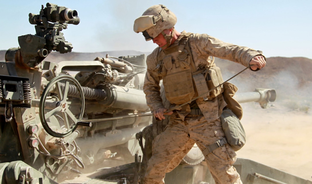 Lance Cpl. James R. Gould, II, artilleryman, Battery C, 1st Battalion, 11th Marine Regiment, pulls a riring pin for a M777A2 Howitzer at the Combat Center's Rainbow Canyon Training Area April 23, 2013. (Official USMC photo by Cpl. William J. Jackson/Released)