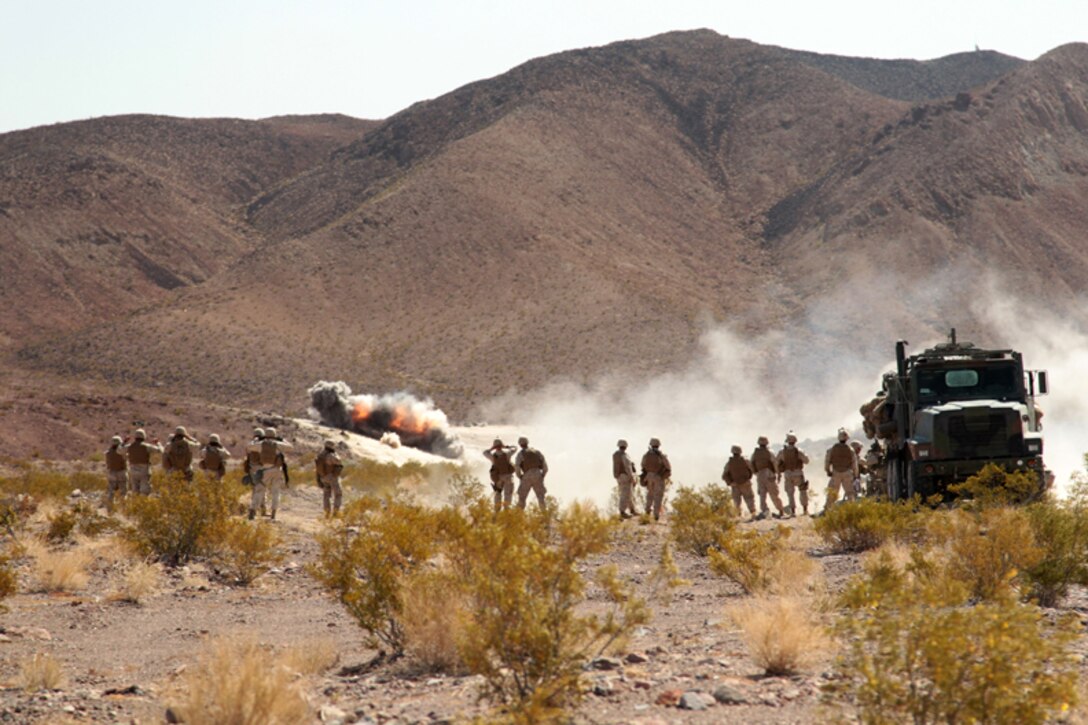 Marines with Battery C, 1st Battalion, 11th Marine Regiment and Battery I, 3rd Battalion, 12th Marine Regiment watch direct fire support training at the Combat Center's Rainbow Canyon Training Area April 23, 2013. (Official USMC photo by Cpl. Ali Azimi/Released)
