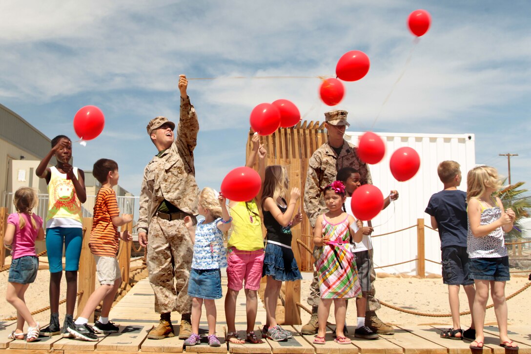 3rd Combat Engineer Battalion Marines, sailors and children release balloons that carry letters written by the children to their parents, who deployed to Afghanistan last month during the unit’s Deployment Workshop Saturday. 