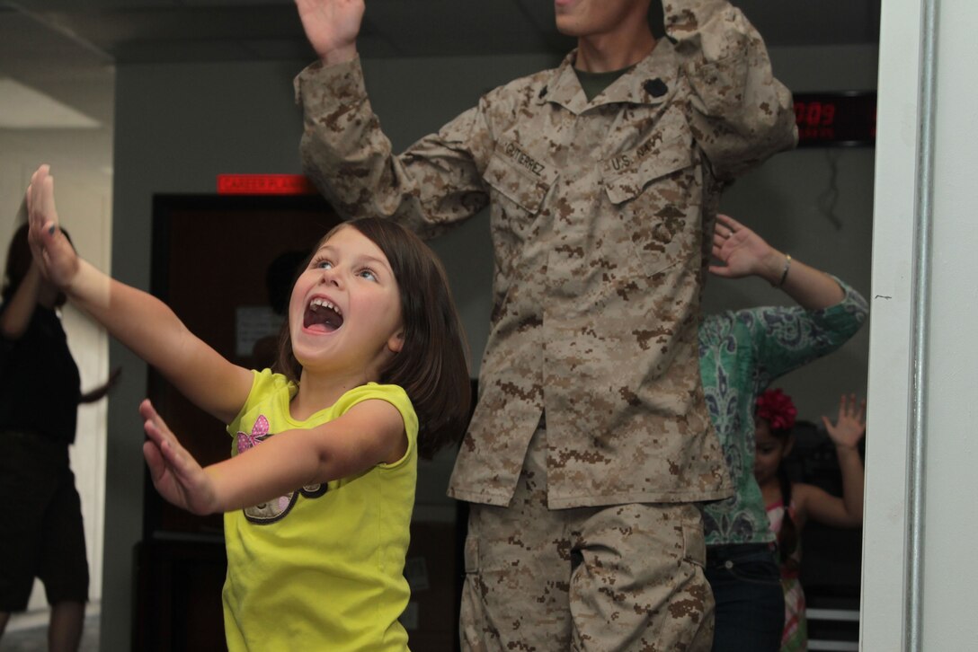 Bailey Salisbury, 5, dances to the sound of music playing at 3rd Combat Engineer Battalion’s compound during their deployment workshop April 19, 2013.