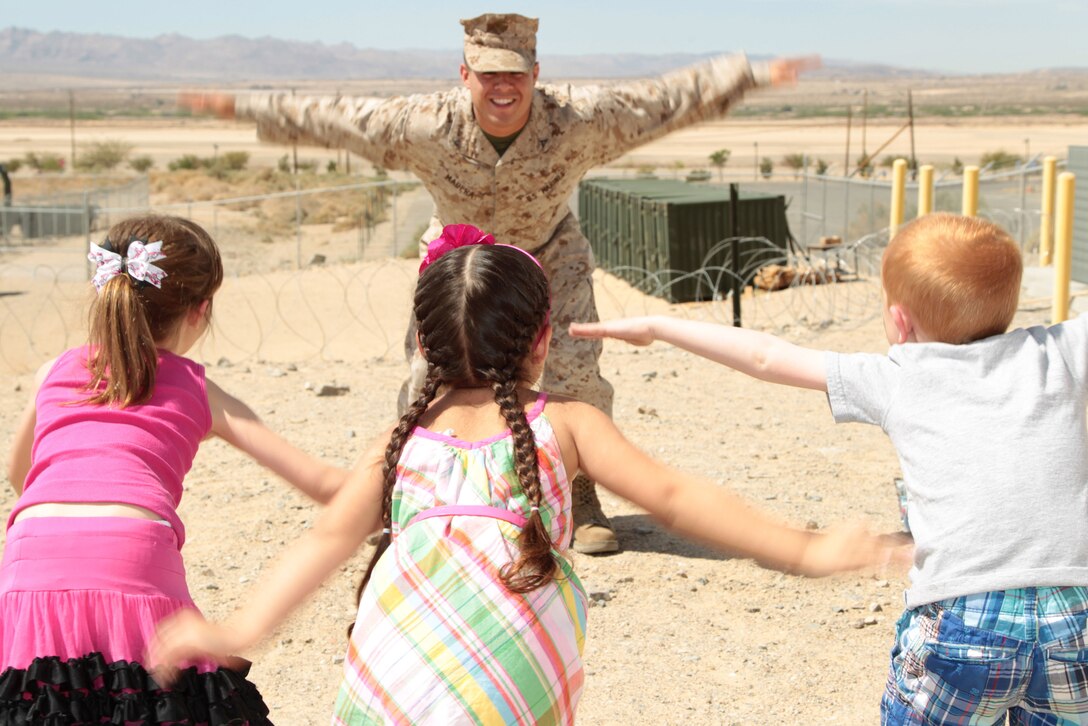 ance Cpl. Ricky Madera, intelligence clerk, 3rd Combat Engineer Battalion, plays “Lance Corporal Says” with kids of currently deployed unit members Saturday as part of 3rd CEB’s deployment workshop. 
