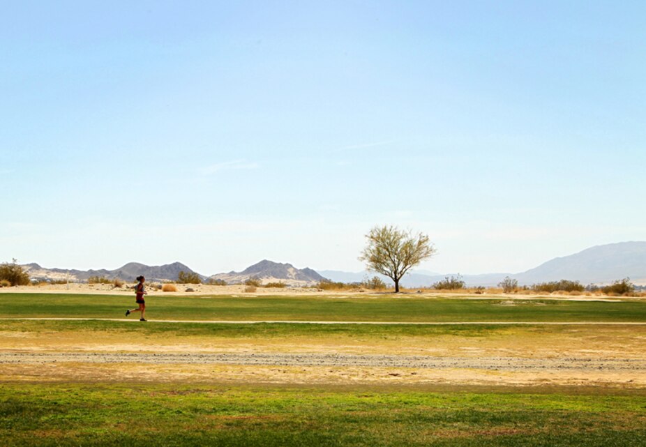 Lacy Richey, a participant in a 5 kilometer run supporting Sexual Assault Awareness Month, races through the Combat Center’s Desert Winds Golf Course April 12,2013.