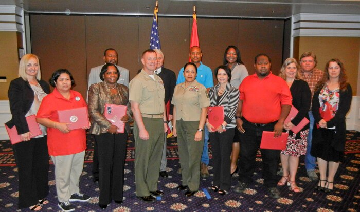 Quantico honors civilians of the quarter and civilian lengths of service. From left are Rebecca Childress, junior civilian of the quarter; Delilah Amen; Bobby Brown; Martha Harris; Col. David Maxwell, base commander; Ken Pittman, senior civilian of the quarter; Sgt. Maj. Laura Brown, base sergeant major; Byron Flakes; Fatima McCoy; Leslie Nicole Perry; Jonathan McKinney; Betty Mayfield; Ronald Moyer; and Sherry Schaarshmidt. 
