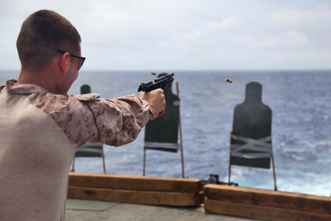 130429-M-VZ265-096 USS RUSHMORE (April 29, 2013) Sergeant Dustin Z. Gibbs, military policeman, Military Police Detachment, Combat Logistics Battalion 15, 15th Marine Expeditionary Unit, fires a M9 Pistol during a live-fire exercise on the flight deck of USS Rushmore, April 29. The servicemembers fired more than 14,000 rounds to ensure everyone was proficient with all of the battalion’s weapon systems. The 15th MEU is comprised of approximately 2,400 Marines and sailors and is deployed as part of the Peleliu Amphibious Ready Group. Together, they provide a forward-deployed, flexible sea-based Marine Air Ground Task Force capable of conducting a wide variety of operations ranging from humanitarian aid to combat. Gibbs, 23, is from Oceanside, Calif. (U.S. Marine Corps photo by Cpl. Timothy Childers/Released)
