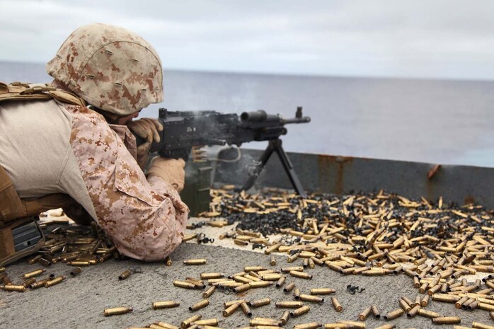 USS RUSHMORE (April 29, 2013) A Marine assigned to Combat Logistics Battalion 15, 15th Marine Expeditionary Unit, fires a M240B machine gun during a live-fire exercise on the flight deck of USS Rushmore, April 29. The servicemembers fired more than 14,000 rounds to ensure everyone was proficient with all of the battalion’s weapon systems. The 15th MEU is comprised of approximately 2,400 Marines and sailors and is deployed as part of the Peleliu Amphibious Ready Group. Together, they provide a forward-deployed, flexible sea-based Marine Air Ground Task Force capable of conducting a wide variety of operations ranging from humanitarian aid to combat. (U.S. Marine Corps photo by Cpl. Timothy Childers/Released)
