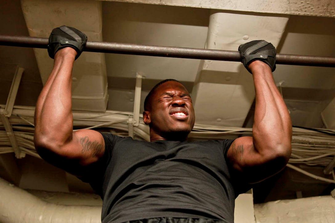 USS PELELIU (April 28, 2013) Lance Cpl. Lacaundus O. McBride, rifleman, 3rd Platoon, Kilo Company, Battalion Landing Team 3/5, 15th Marine Expeditionary Unit, pulls himself up to the bar during the Campbell Cup held in the gym of USS Peleliu, April 28. The challenge was the final competition of the Campbell Cup, a competition that brought teams from within the 15th Marine Expeditionary Unit and Peleliu Amphibious Ready Group against each other. This two-night event pitted the Command Element’s team against Kilo Company’s team in a showdown for the coveted Campbell Cup. The 15th MEU is deployed as part of the Peleliu Amphibious Ready Group and is comprised of approximately 2,400 Marines and sailors. Together with Amphibious Squadron Three, they provide a forward-deployed, flexible sea-based Marine Air Ground Task Force capable of conducting a wide variety of operations ranging from humanitarian aid to combat. McBride, 20, is from Macon, Ga. (U.S. Marine Corps photo by Cpl. John Robbart III/Released)