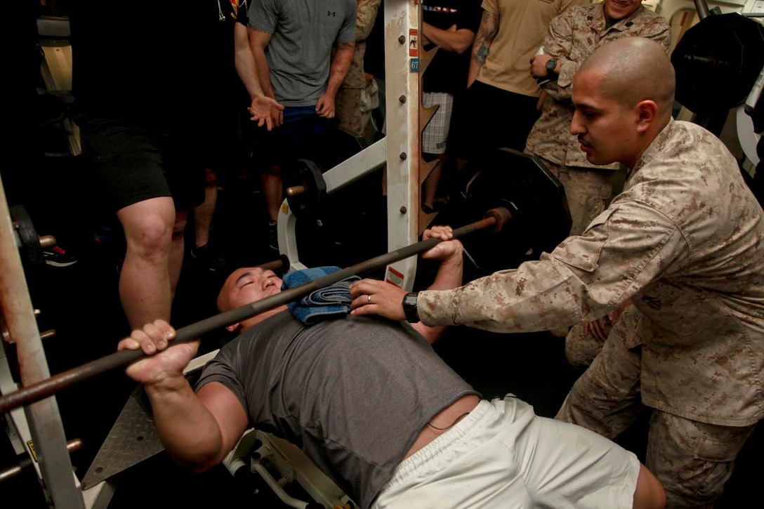 USS PELELIU (April 28, 2013) Sergeant Nathan Y. Shay, data chief, Command Element, 15th Marine Expeditionary Unit, bench presses 205 pounds as many times as he can during the Campbell Cup held in the gym of USS Peleliu, April 28. The challenge was the final competition of the Campbell Cup, a competition that brought teams from within the 15th Marine Expeditionary Unit and Peleliu Amphibious Ready Group against each other. This two-night event pitted the Command Element’s team against Kilo Company’s team in a showdown for the coveted Campbell Cup. The 15th MEU is deployed as part of the Peleliu Amphibious Ready Group and is comprised of approximately 2,400 Marines and sailors. Together with Amphibious Squadron Three, they provide a forward-deployed, flexible sea-based Marine Air Ground Task Force capable of conducting a wide variety of operations ranging from humanitarian aid to combat. Shay, 26, is from Tualatin, Ore. (U.S. Marine Corps photo by Cpl. John Robbart III/Released)