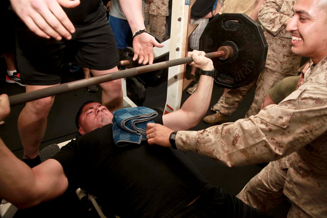 USS PELELIU (April 28, 2013) Private First Class Chris C. Pelfrey, rifleman, 3rd Platoon, Kilo Company, Battalion Landing Team 3/5, 15th Marine Expeditionary Unit, bench presses 205 pounds as many times as he can during the Campbell Cup held in the gym of USS Peleliu, April 28. The challenge was the final competition of the Campbell Cup, a competition that brought teams from within the 15th Marine Expeditionary Unit and Peleliu Amphibious Ready Group against each other. This two-night event pitted the Command Element’s team against Kilo Company’s team in a showdown for the coveted Campbell Cup. The 15th MEU is deployed as part of the Peleliu Amphibious Ready Group and is comprised of approximately 2,400 Marines and sailors. Together with Amphibious Squadron Three, they provide a forward-deployed, flexible sea-based Marine Air Ground Task Force capable of conducting a wide variety of operations ranging from humanitarian aid to combat. Pelfrey, 22, is from Biloxi, Miss. (U.S. Marine Corps photo by Cpl. John Robbart III/Released)