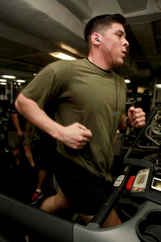 USS PELELIU (April 27, 2013) Lance Cpl. Alex Fisher, squad automatic weapon gunner, Security Platoon, Maritime Raid Force, 15th Marine Expeditionary Unit, runs on a treadmill for an event during the Campbell Cup held in the gym of USS Peleliu, April 27. The challenge was the final competition of the Campbell Cup, a competition that brought teams from within the 15th Marine Expeditionary Unit and Peleliu Amphibious Ready Group against each other. This two-night event pitted the Command Element’s team against Kilo Company’s team in a showdown for the coveted Campbell Cup. The 15th MEU is deployed as part of the Peleliu Amphibious Ready Group and is comprised of approximately 2,400 Marines and sailors. Together with Amphibious Squadron Three, they provide a forward-deployed, flexible sea-based Marine Air Ground Task Force capable of conducting a wide variety of operations ranging from humanitarian aid to combat. Fisher, 21, is from Los Angeles. (U.S. Marine Corps photo by Cpl. John Robbart III/Released)