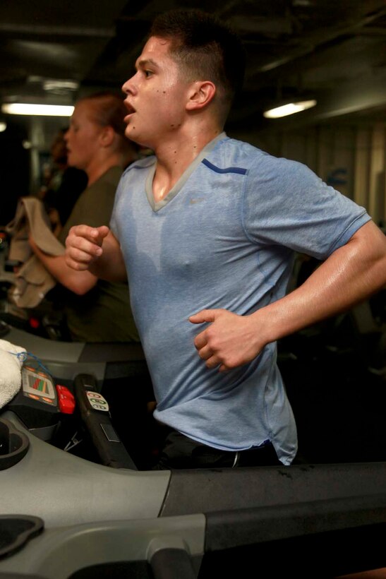 USS PELELIU (April 27, 2013) Lance Cpl. Rodrigo Duran Jr., machine gunner, Weapons Platoon, Kilo Company, Battalion Landing Team 3/5, 15th Marine Expeditionary Unit, runs on a treadmill for an event during the Campbell Cup held in the gym of USS Peleliu, April 27. The challenge was the final competition of the Campbell Cup, a competition that brought teams from within the 15th Marine Expeditionary Unit and Peleliu Amphibious Ready Group against each other. This two-night event pitted the Command Element’s team against Kilo Company’s team in a showdown for the coveted Campbell Cup. The 15th MEU is deployed as part of the Peleliu Amphibious Ready Group and is comprised of approximately 2,400 Marines and sailors. Together with Amphibious Squadron Three, they provide a forward-deployed, flexible sea-based Marine Air Ground Task Force capable of conducting a wide variety of operations ranging from humanitarian aid to combat. Duran, 20, is from Los Angeles. (U.S. Marine Corps photo by Cpl. John Robbart III/Released)