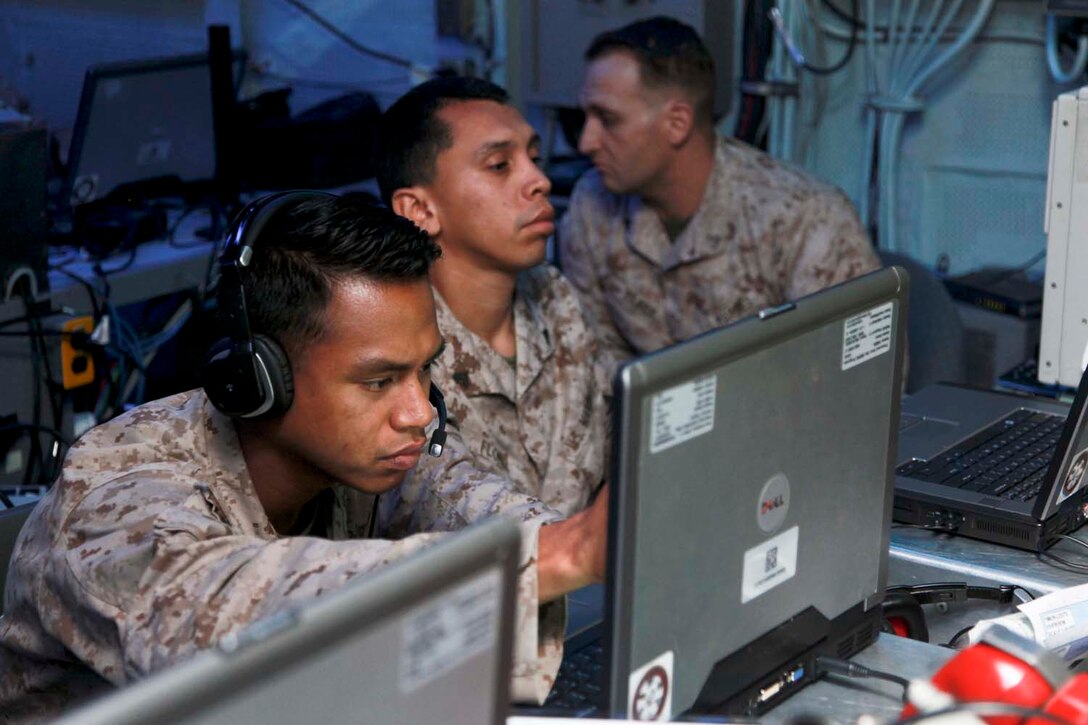 USS PELELIU (April 26, 2013) Squad leaders from Security Platoon, Maritime Raid Force, 15th Marine Expeditionary Unit, practice calling for fire using the Digital Virtual Training Environment during a modified joint fires observer class on USS Peleliu, April 26. Calling for fire or calling in a casualty evacuation are tasks normally associated with a scout observer or joint terminal attack controller who are a part of the artillery military occupational field, but specialize in controlling aircraft for specific missions. The scout observers with the Command Element, 15th MEU, held a class to help prepare the MRF for the variety of missions that scout observers typically conduct such as controlling aircraft for air strikes or requesting casualty evacuations. The 15th MEU is deployed as part of the Peleliu Amphibious Ready Group and is comprised of approximately 2,400 Marines and sailors. Together with Amphibious Squadron Three, they provide a forward-deployed, flexible sea-based Marine Air Ground Task Force capable of conducting a wide variety of operations ranging from humanitarian aid to combat. (U.S. Marine Corps photo by Cpl. John Robbart III/Released)