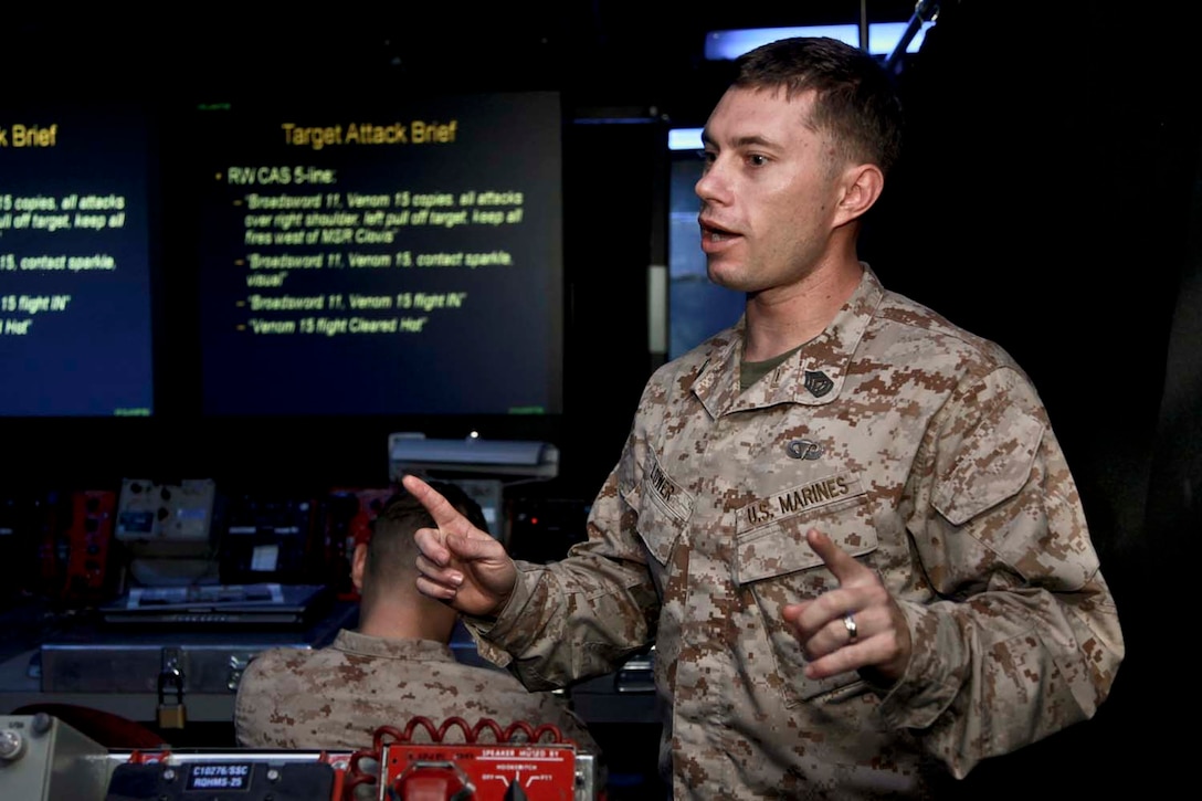 USS PELELIU (April 25, 2013) Gunnery Sgt. Robert L. Lower, fires chief, 15th Marine Expeditionary Unit, gives a modified joint fires observer class to Marines with the unit’s Maritime Raid Force on USS Peleliu, April 25. Calling for fire or calling in a casualty evacuation are tasks normally associated with scout observers or joint terminal attack controllers. These Marines, many in the ground occupational field, specialize in controlling aircraft. The scout observers with the Command Element, 15th MEU, held a class to help prepare the MRF for the variety of missions that scout observers typically conduct such as controlling aircraft for air strikes or requesting casualty evacuations. The 15th MEU is deployed as part of the Peleliu Amphibious Ready Group and is comprised of approximately 2,400 Marines and sailors. Together with Amphibious Squadron Three, they provide a forward-deployed, flexible sea-based Marine Air Ground Task Force capable of conducting a wide variety of operations ranging from humanitarian aid to combat. Lower, 31, is from La Porte, Ind. (U.S. Marine Corps photo by Cpl. John Robbart III/Released)