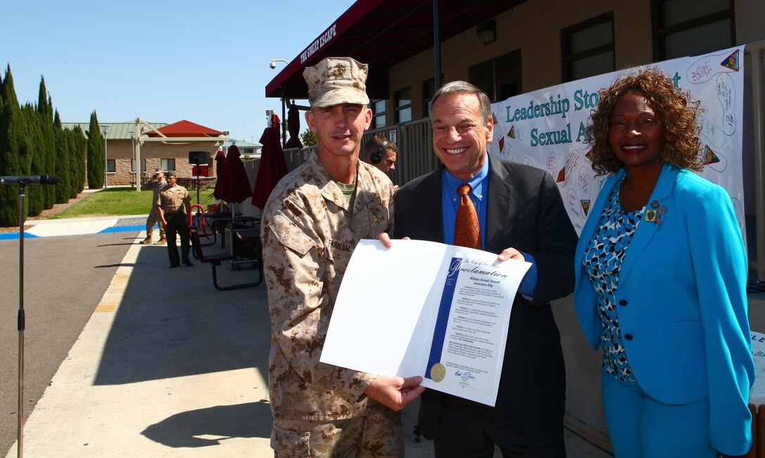 Col. John Farnam, left, the commanding officer of Marine Corps Air Station Miramar, poses for a photo with San Diego Mayor, Bob Filner, center, and Tara Jones, right, the guest of honor and founder of the National Women Veterans Association of America, before the 4th Annual Sexual Assault Awareness Month Walk aboard MCAS Miramar, Calif., April 26. Before the ceremony began, Mayor Filner proclaimed this day shall forever be marked as Sexual Assault Awareness Day in the city of San Diego.