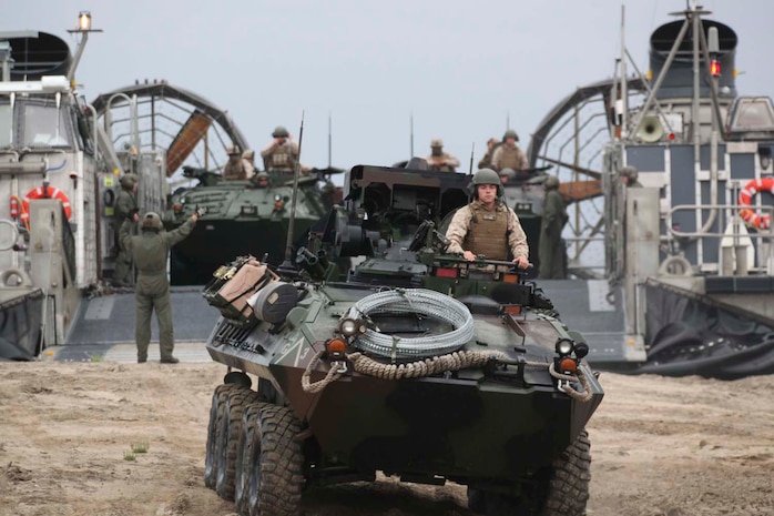A light armored vehicle carrying Marines serving with Alpha Company, 1st Light Armored Reconnaissance Battalion unloaded out of a landing craft air cushion during a strategic mobility exercise here, April 29, 2013. Landing craft air cushions are capable of carrying up to 65 tons over 70 miles between land and sea. The Marines learned the basics of loading and unloading from the hovercraft to prepare for upcoming deployments.   (U.S. Marine Corps photo Cpl. Robert J. Reeves/Released)