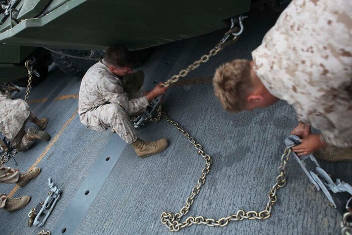 Marines serving with Alpha Company, 1st Light Armored Reconnaissance Battalion, practice "griping," a process to tie down their light armored vehicles to landing craft air cushion, before amphibious landing here, April 29, 2013. Landing craft air cushions are capable of carrying up to 65 tons over 70 miles between land and sea. The Marines learned the basics of loading and unloading from the hovercraft to prepare for upcoming deployments. (U.S. Marine Corps photo Cpl. Robert J. Reeves/Released)