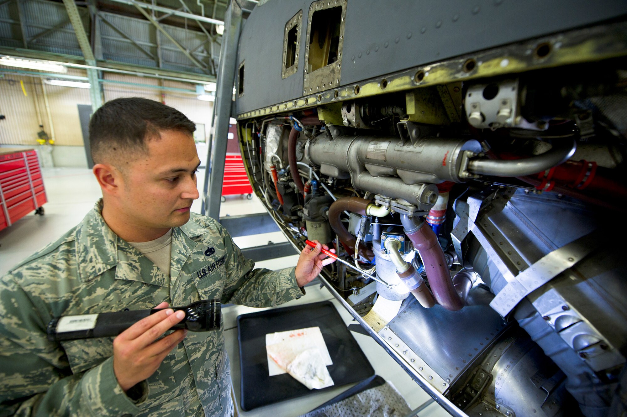 YOKOTA AIR BASE, Japan -- Tech. Sgt.  Randy Bailes, 374th Maintenance Operation Squadron quality assurance, inspects an engine after repairs have been made April 17, 2013, at Yokota Air Base, Japan. Bailes does his part to assure maintainers are complying with and meeting standards by conducting inspections. (U.S. Air Force photo by Staff Sgt. Stacy Moless)