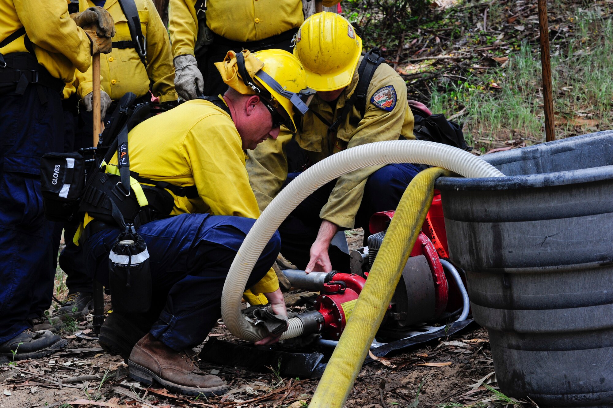 VANDENBERG AIR FORCE BASE, Calif. – 30th Civil Engineer Squadron firefighters remove a hose from a Mark-3 fire pump here Tuesday, April 30, 2013. The firefighters were participating in Vandenberg’s Annual Wildland Fire Academy, which is designed to keep Team V’s firefighters mission ready. (U.S. Air Force photo/Airman Yvonne Morales)
