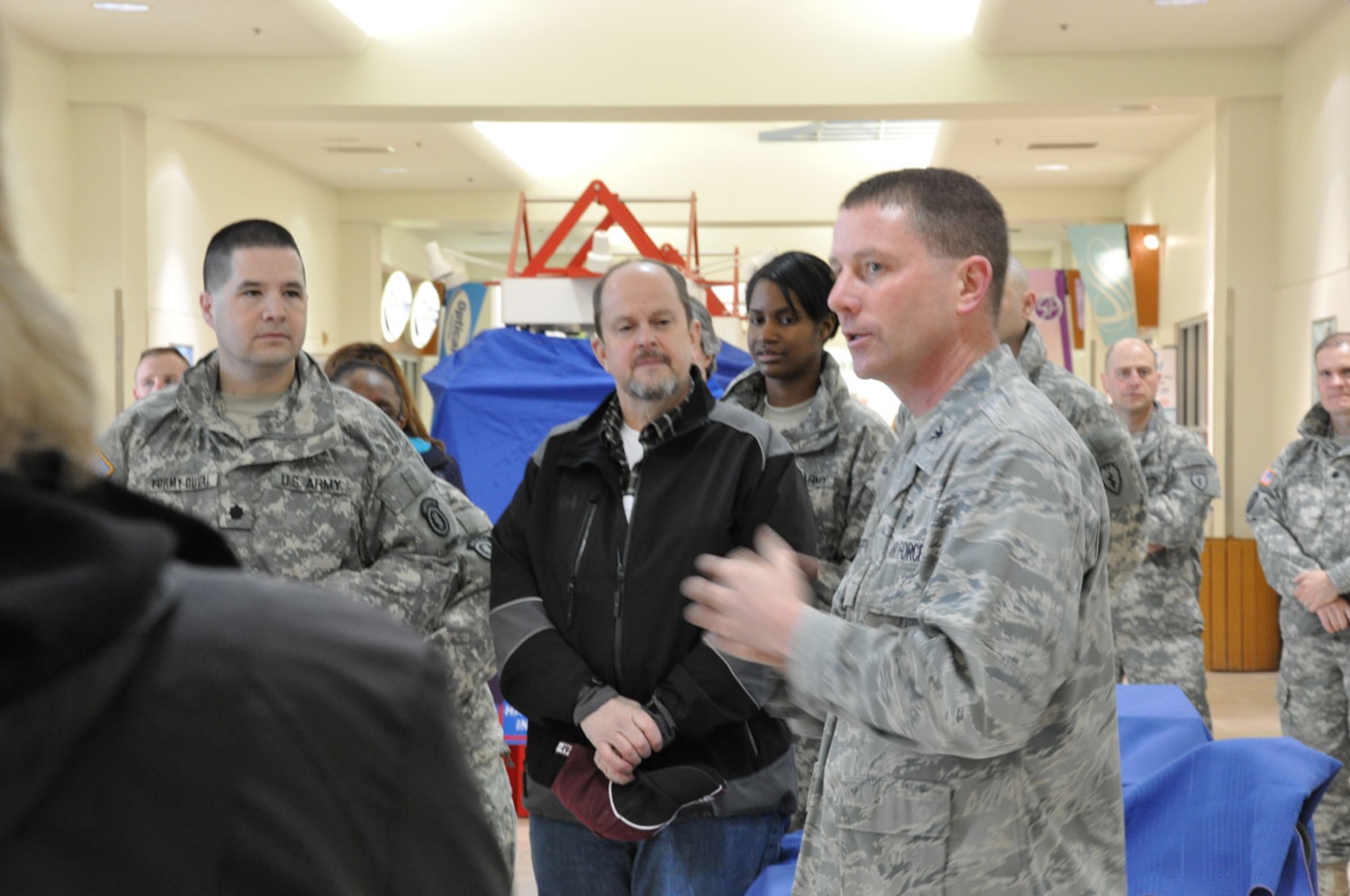 Air Force Col. Brian Duffy, commander of JBER and the 673d Air Base Wing, and Army Lt. Col. Brian Formy-Duval, 17th Combat Sustainment Support Battalion commander, greet Ben Hardwick, Ursa Major Elementary School principal and other tour participants to JBER.  Anchorage School District leadership partnered with various Army and Air Force units at JBER visited the installation to learn more about how a military lifestyle may impact students. (U.S. Air Force photo/Song Jordan)