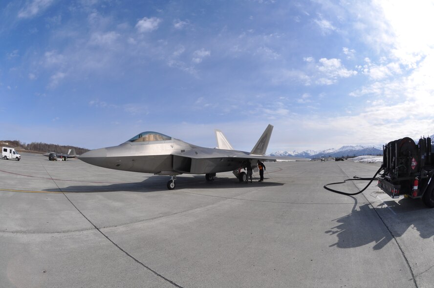 Airmen from the 3rd and 477th Aircraft Maintenance Squadrons perform a hot
pit refuel with an F-22 here May 1. Hot pit refueling is a procedure
performed in order to rapidly refuel the aircraft and allow it to complete a
second sortie in a short amount of time. During a hot pit refuel the pilot
will stay in the cockpit with the jet running while the maintenance crews
perform safety checks and refuel the aircraft allowing it to return to
flight in less than 30 minutes.  (U.S. Air Force photo/Tech. Sgt. Dana Rosso)
