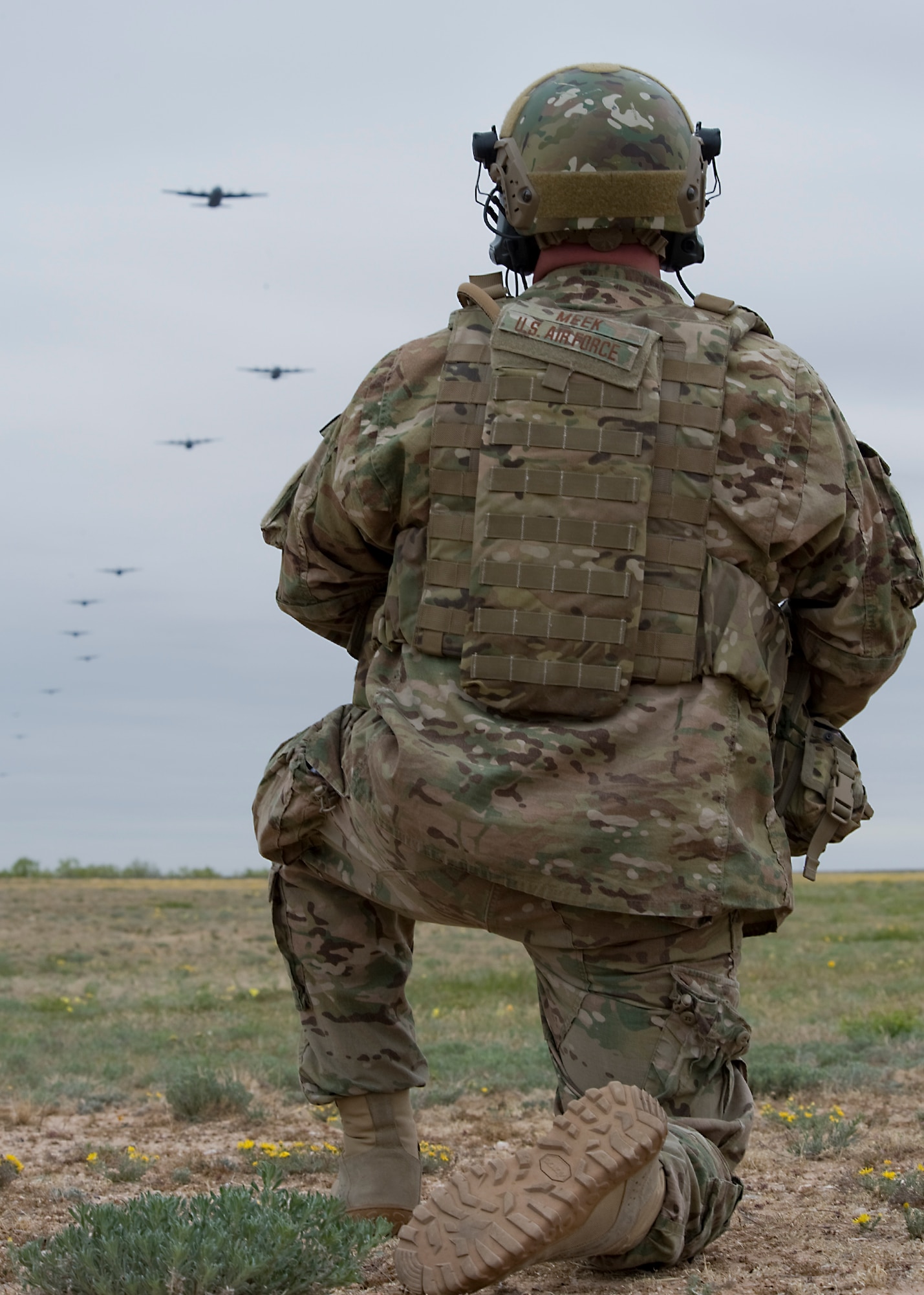 U.S. Air Force Tech. Sgt. Jason Meek, a Joint Terminal Attack Controller (JTAC) with the 66th Weapons Squadron, Nellis Air Force Base, Nev., coordinates with 12 C-130Js from Dyess Air Force Base, Texas, during a joint force integration exercise April 25, 2013, at Winston Field Airport in Snyder, Texas. JTACs provided critical information during a simulated airfield seizure to strengthen training, safety and efficiency of working with multiple aircraft of different capabilities. (U.S. Air Force photo by Airman 1st Class Peter Thompson/Released)