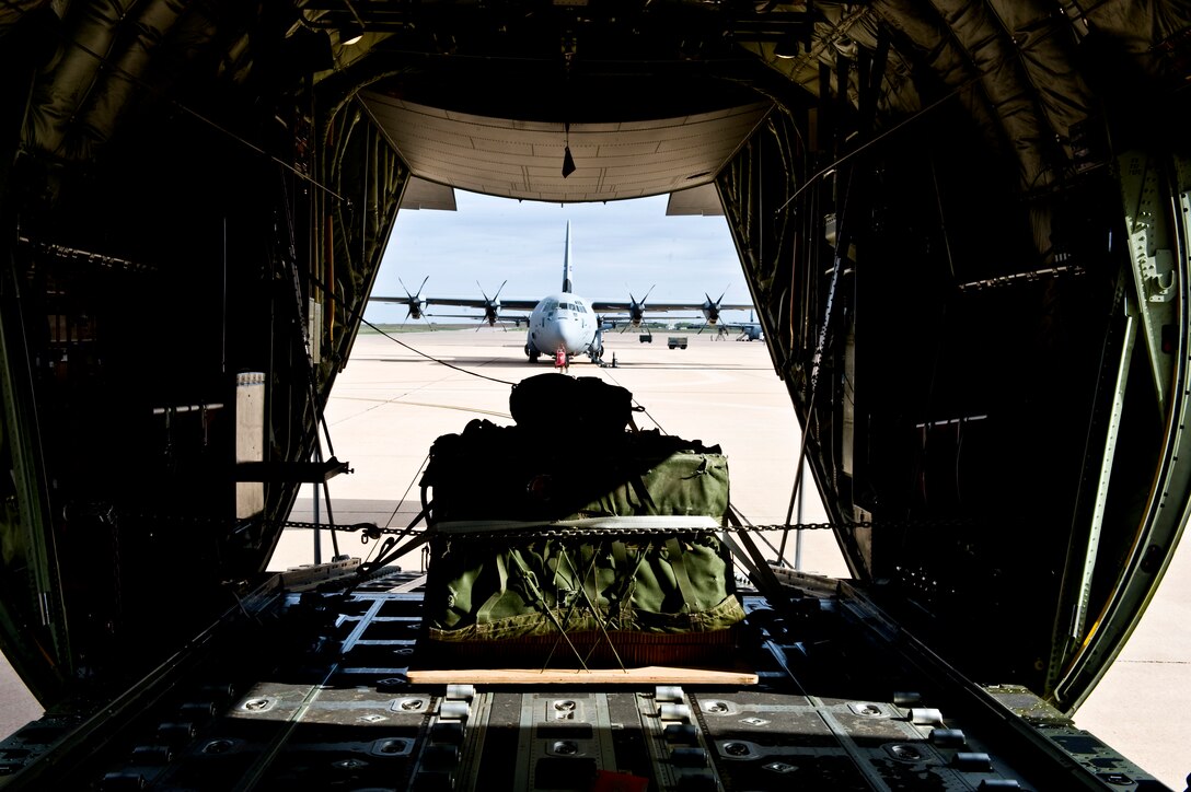 A bundle of cargo is secured to the back of a C-130J prior to take off April 25, 2013, at Dyess Air Force Base, Texas. Twelve C-130Js took off from Dyess AFB to participate in a joint force integration exercise followed by a large formation airdrop in western Texas. (U.S. Air Force photo by Airman 1st Class Charles Rivezzo/Released)