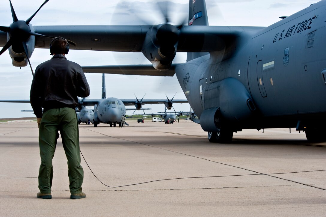 U.S. Air Force Airman 1st Class Ryan Louden, 40th Airlift Squadron (AS), 317th Airlift Group, Dyess Air Force Base, Texas, stands outside of a C-130J during pre-flight inspections April 25, 2013, at Dyess AFB. The 40th AS participated in a joint force integration exercise with other Air Force units, as well as U.S. Marine Corps F/A-18 Hornets, to learn how to better communicate with aircraft and ground forces during a joint operation. (U.S. Air Force photo by Airman 1st Class Charles Rivezzo/Released)