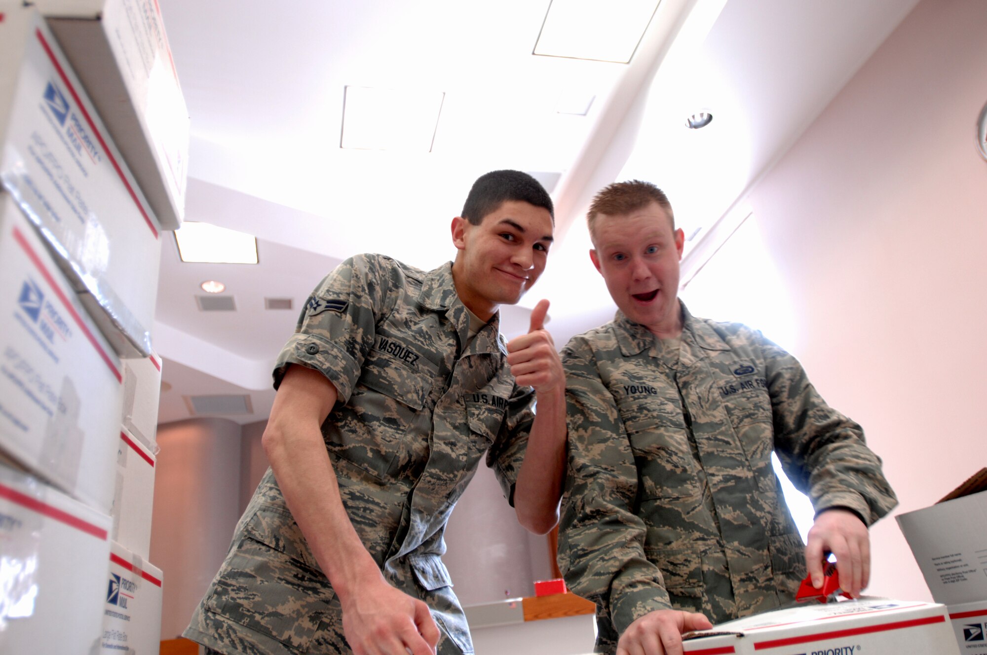 (From left) Airman 1st Class James Vasquez and Staff Sgt. Christopher Young, 319th Force Support Squadron, assemble care packages in Grand Forks city for deployed troops April 27, 2013. About a dozen service members from Grand Forks Air Force Base, N.D., teamed up with the mayor’s office and 35 members of the Grand Forks Youth Commission packed nearly 200 boxes of goods, totaling about $5,500 in value, to be received by about 90 deployed active-duty Airmen and a dozen North Dakota Air National Guardsmen. (U.S. Air Force photo/Staff Sgt. Susan L. Davis)